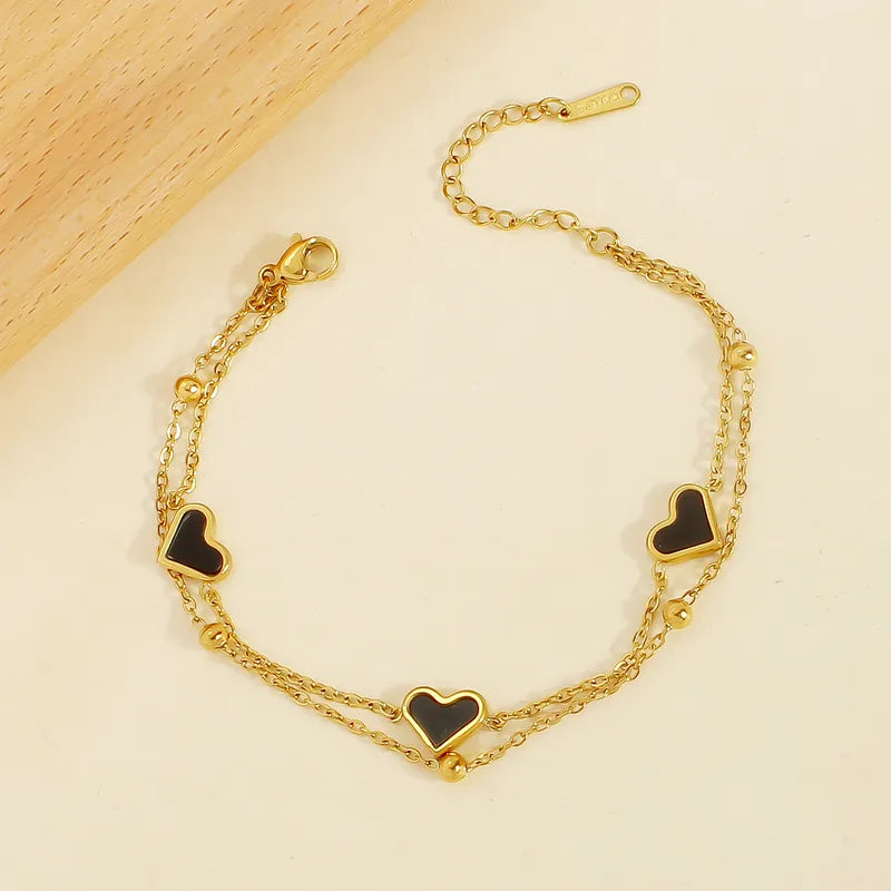 PULSERA DOBLE CORAZONES NEGROS DORADO
