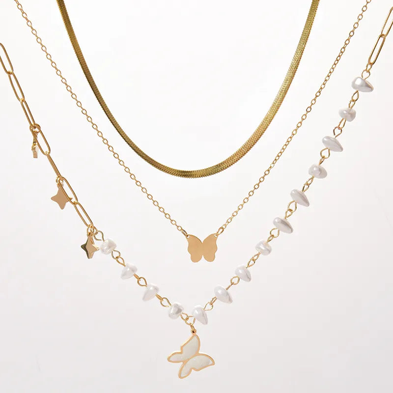 LAYER DE 4 CADENAS MARIPOSAS PERLAS DORADO