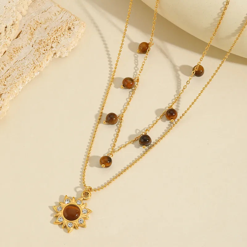 LAYER DOBLE CON PIEDRAS Y DIJE DE GIRASOL