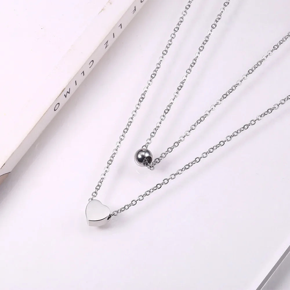 LAYER DOBLE CON DIJE DE CORAZON Y PERLA PLATEADA