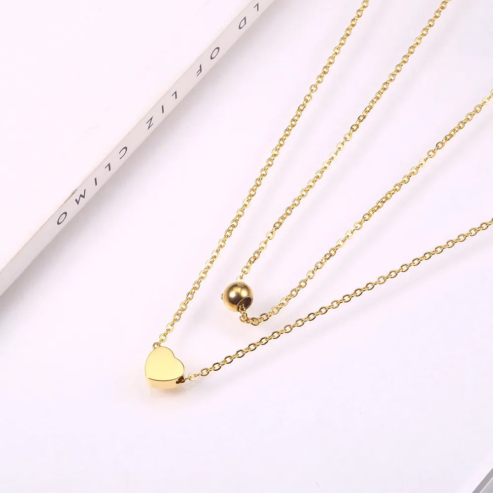 LAYER DOBLE CON DIJE DE CORAZON Y PERLA DORADA