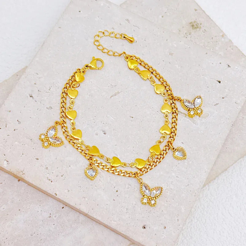 PULSERA DOBLE HILERA CORAZONES CON MARIPOSA DORADO