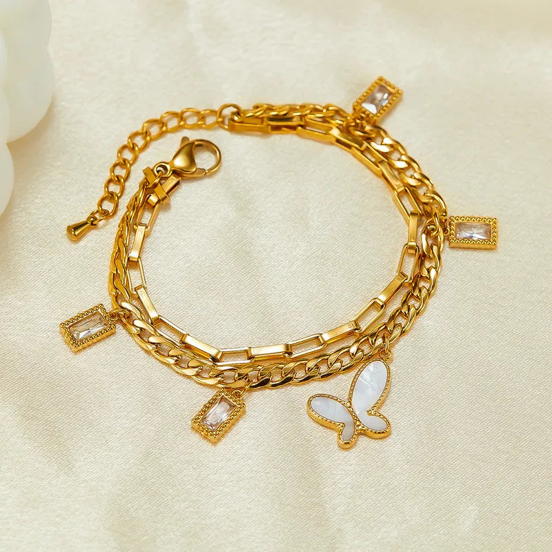PULSERA DOBLE DE ESLABONES CON MARIPOSA BLANCA DORADO