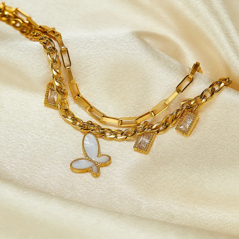 PULSERA DOBLE DE ESLABONES CON MARIPOSA BLANCA DORADO