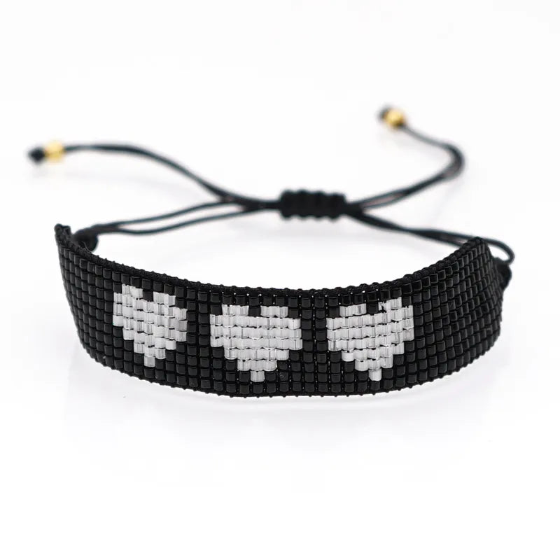 Pulsera negra corazones hielra ajustable