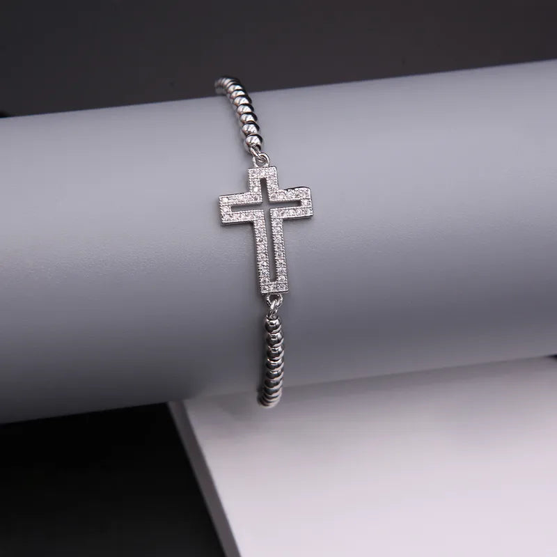 PULSERA AJUSTABLE CRUZ ZIRCONES PLATEADO