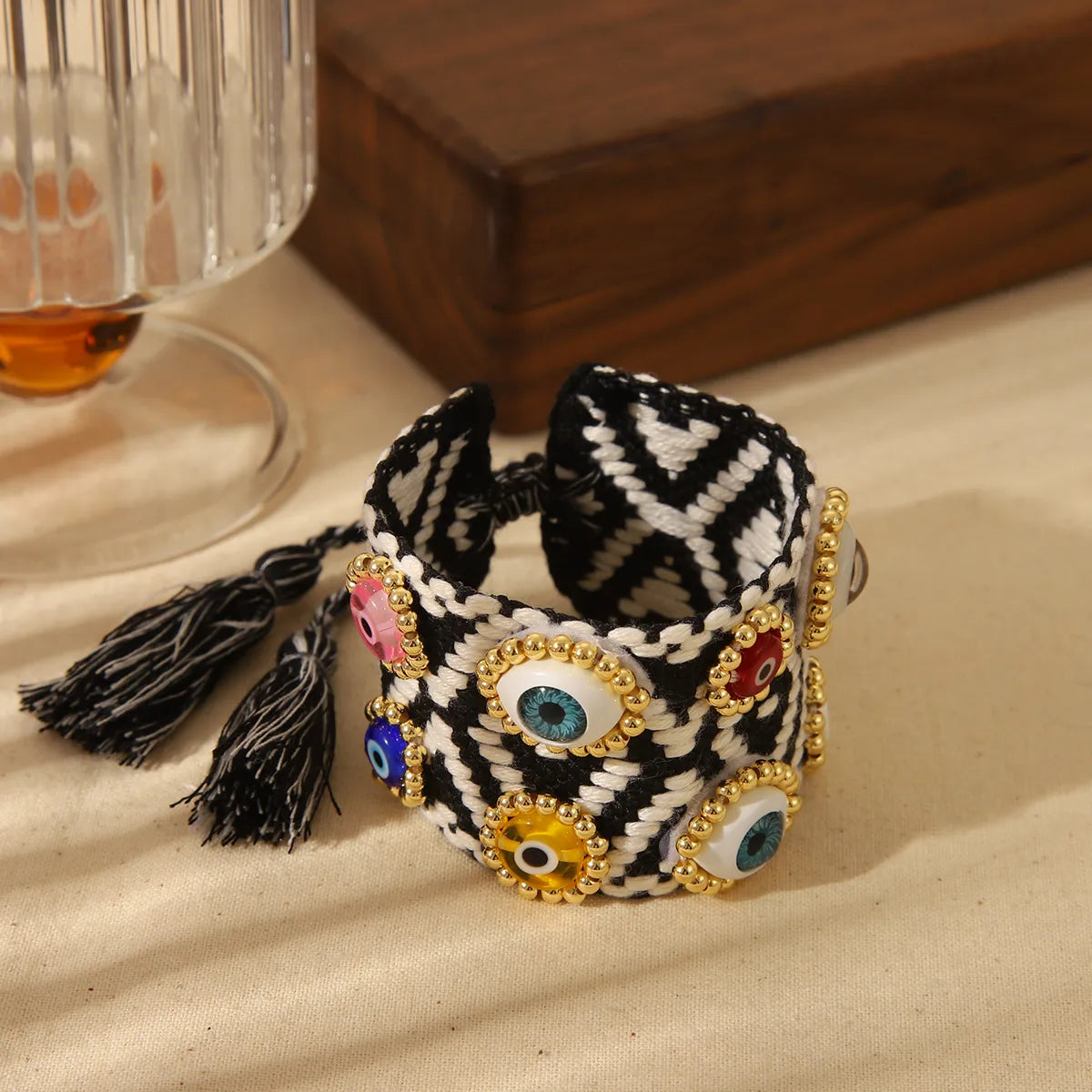 PULSERA TEJIDA OJOS MULTICOLORES NEGRO AJUSTABLE