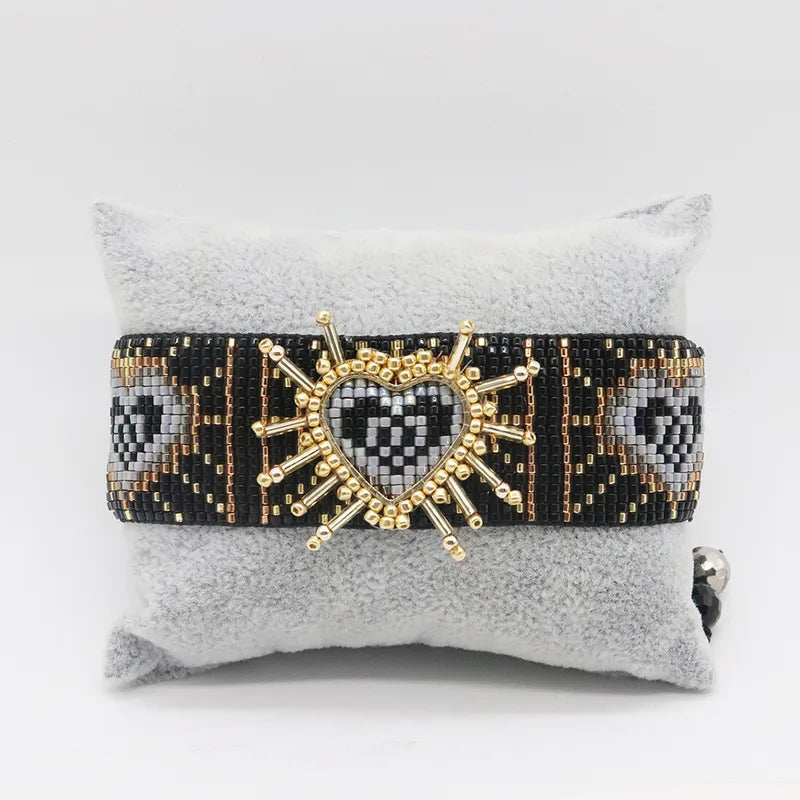 PULSERA DE MULLOS NEGRO TEJIDA DORADO