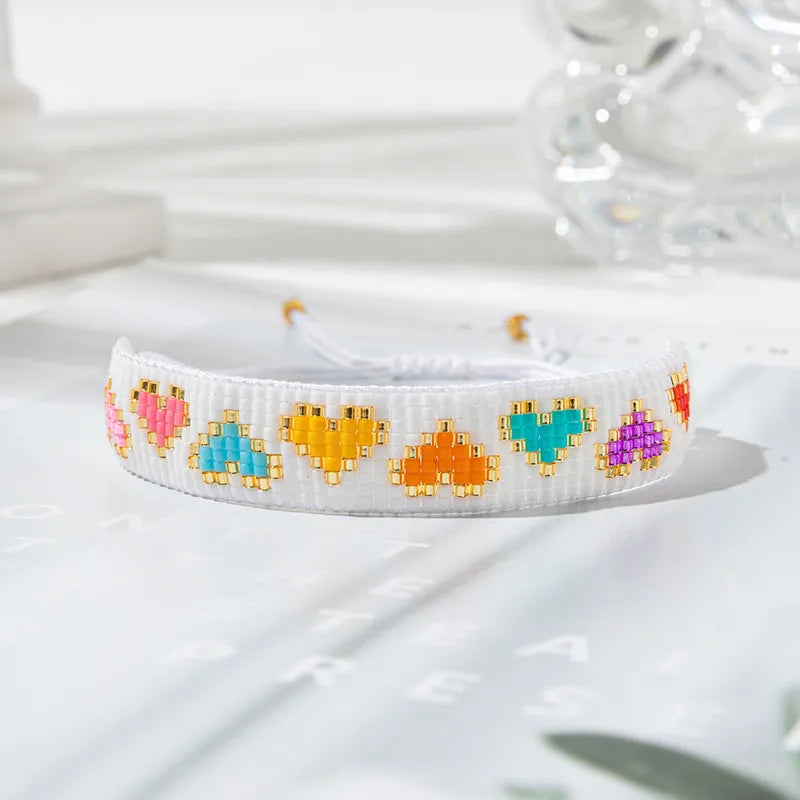 PULSERA TEJIDA MULLOS CORAZONES COLORES BLANCO