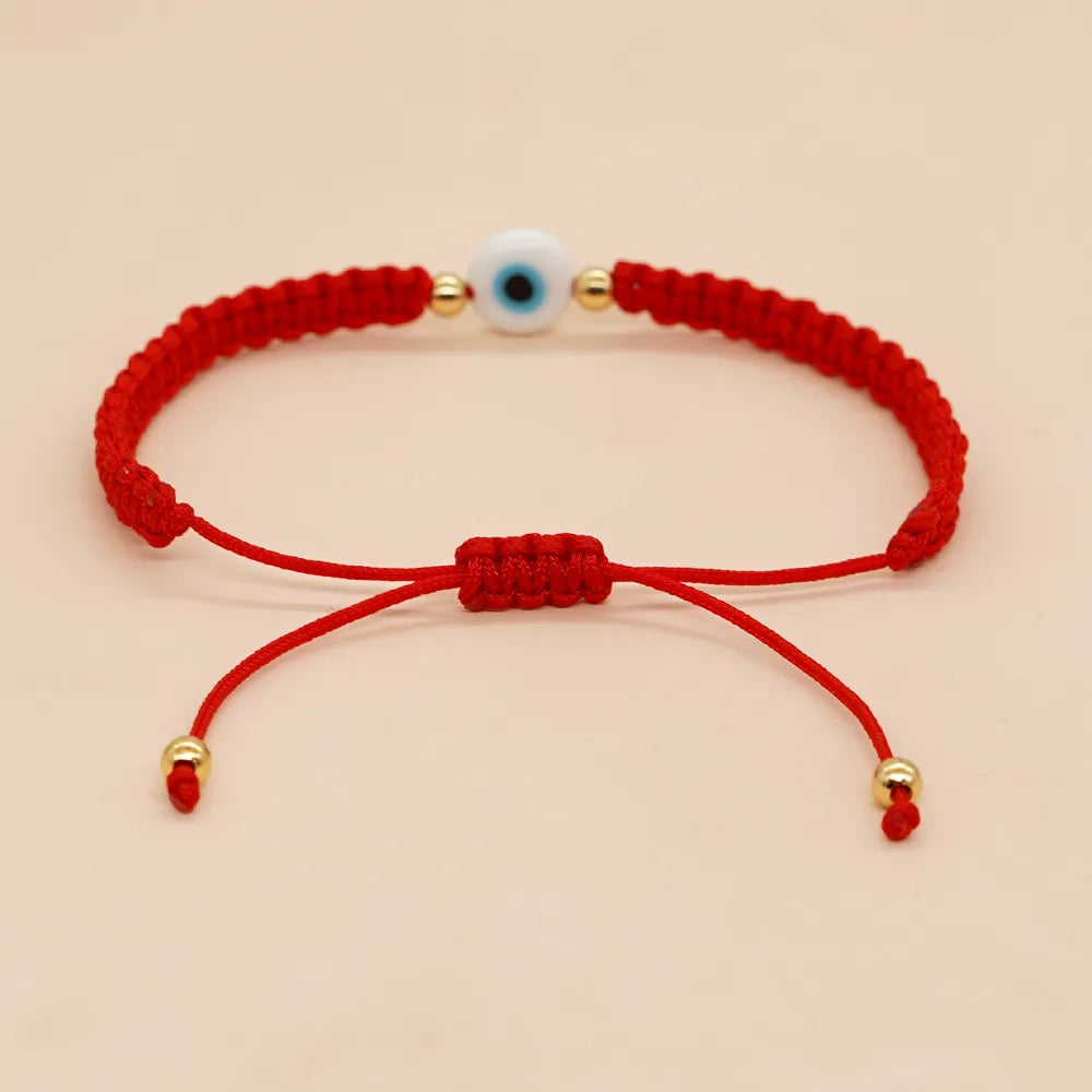 PULSERA HILO ROJO TEJIDO CON OJO BLANCO DORADO