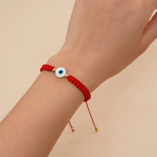 PULSERA HILO ROJO TEJIDO CON OJO BLANCO DORADO