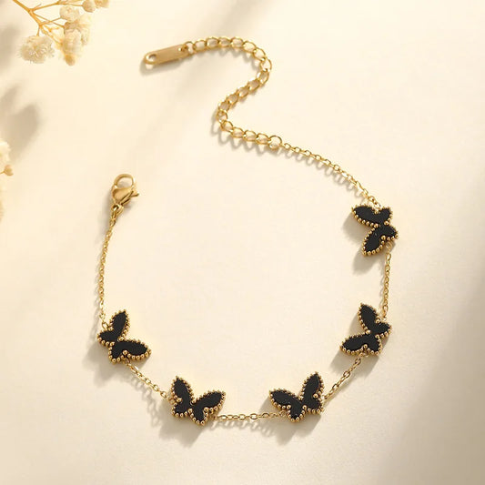 PULSERA HILERA DE AMRIPOSAS NEGRAS DORADO
