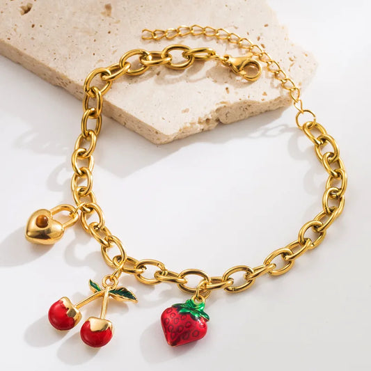 PULSERA DE ESLABONES CON DIJES DE CHERRY CANDADO DORADO