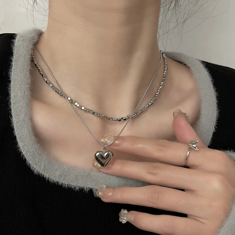 LAYER DOBLE CADENA Y DIJE DE CORAZON PLATEADO