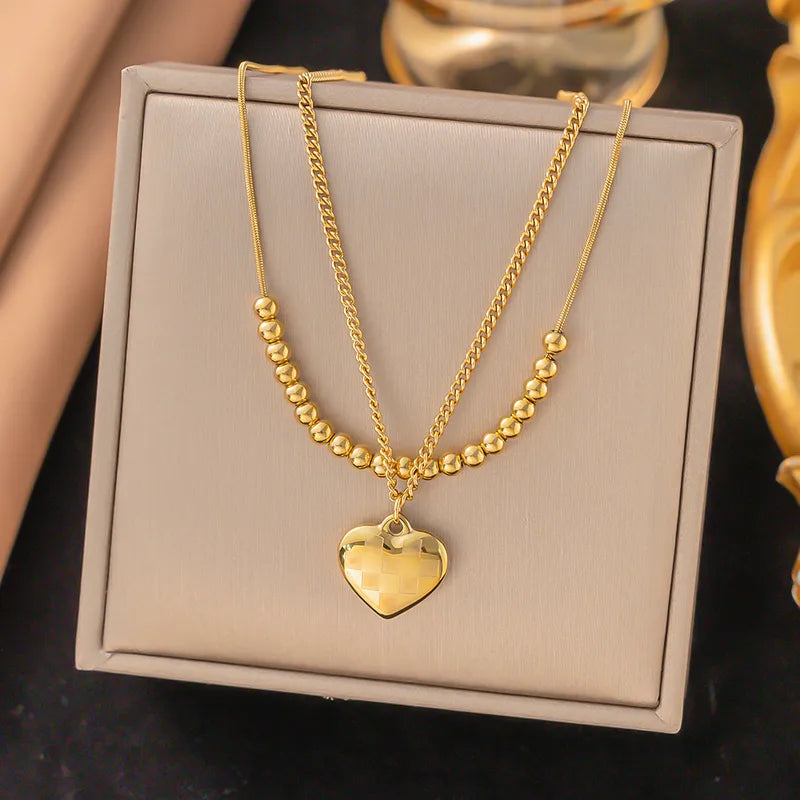 LAYER DOBLE CON PERLAS DORADAS Y DIJE DE CORAZON