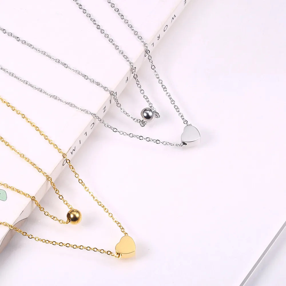 LAYER DOBLE CON DIJE DE CORAZON Y PERLA PLATEADA