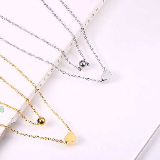 LAYER DOBLE CON DIJE DE CORAZON Y PERLA PLATEADA