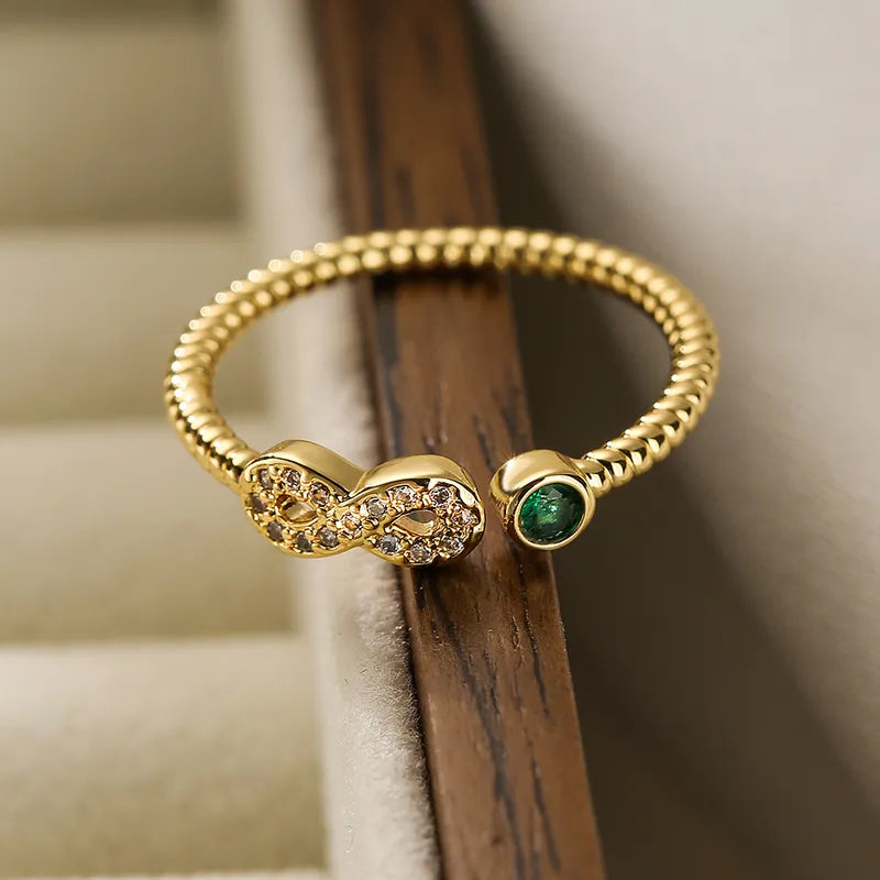 Anillo infinito con zircon verde